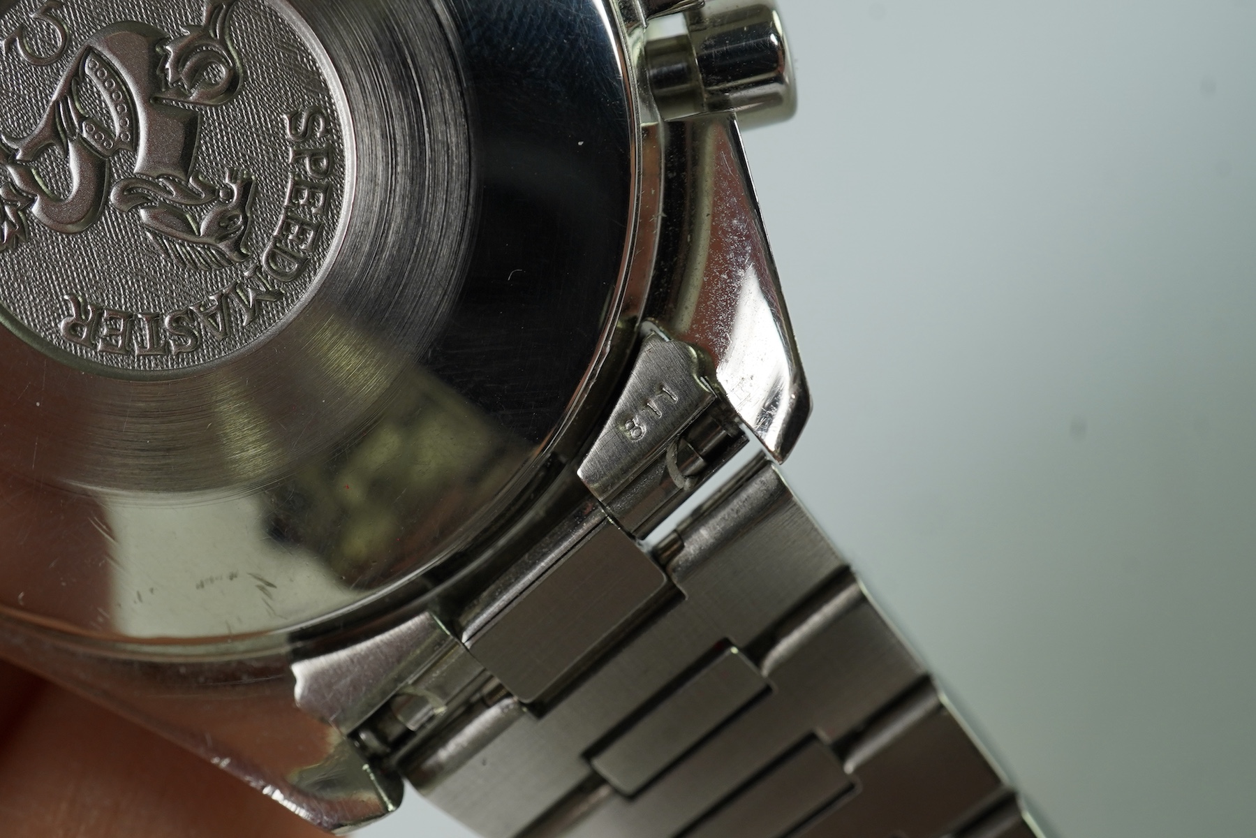 A gentleman's late 1990's stainless steel Omega Speedmaster automatic wrist watch, with box and three pamphlets